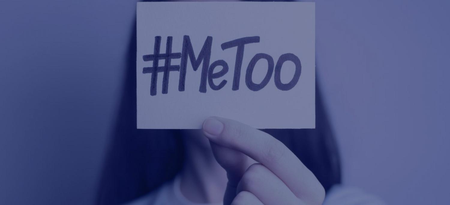 a person holding a paper with #MeToo written on it