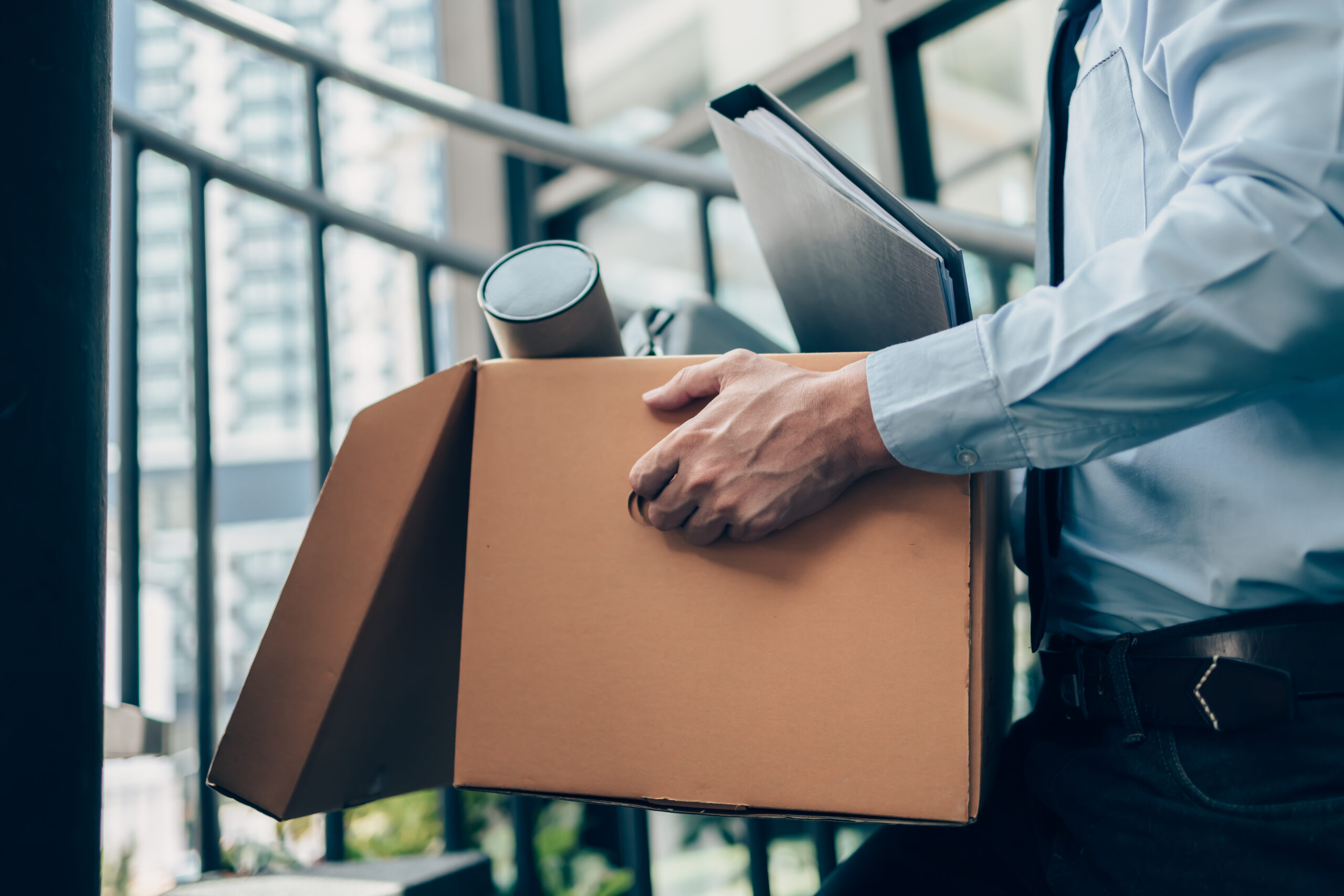 close up of office worker holding a cardboard box with personal office items